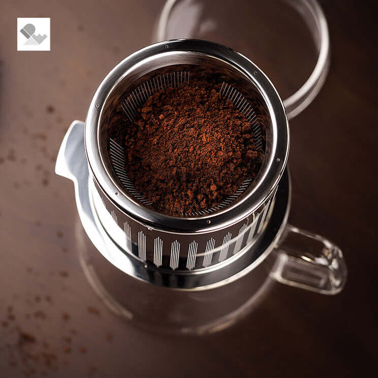 Reversible mesh filter with coffee grounds in Duo Pot for brewing, highlighting award-winning contemporary design and functionality.